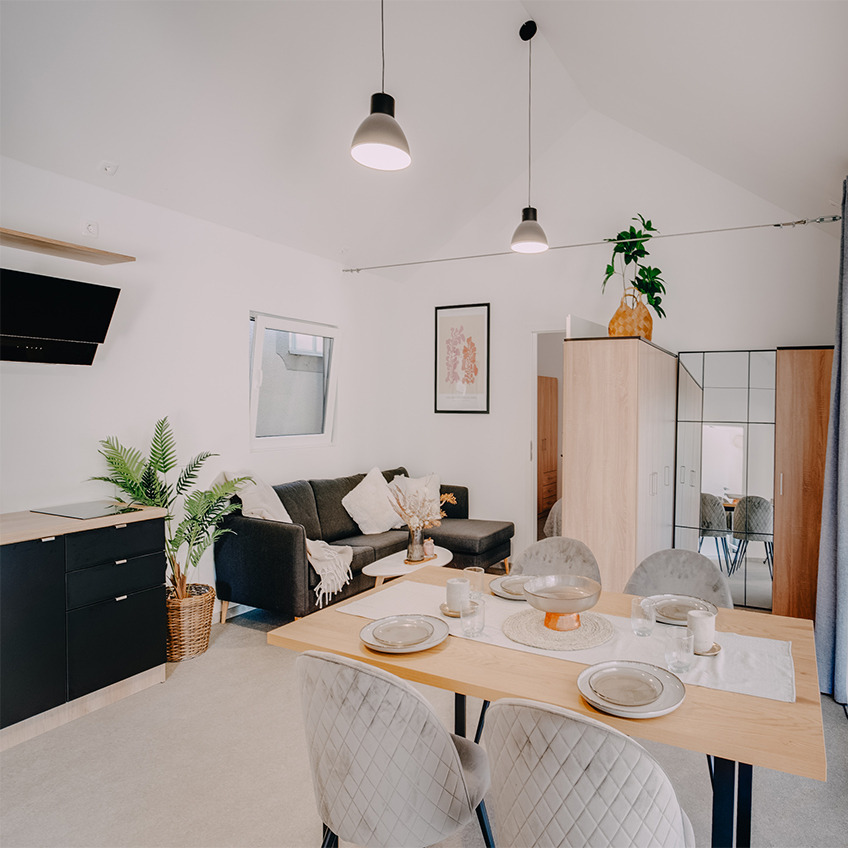 Sofá AARHUS, mesa LEJRE y marco OSCAR Comedor amueblado con mesa de comedor, sillas y accesorios de cocina