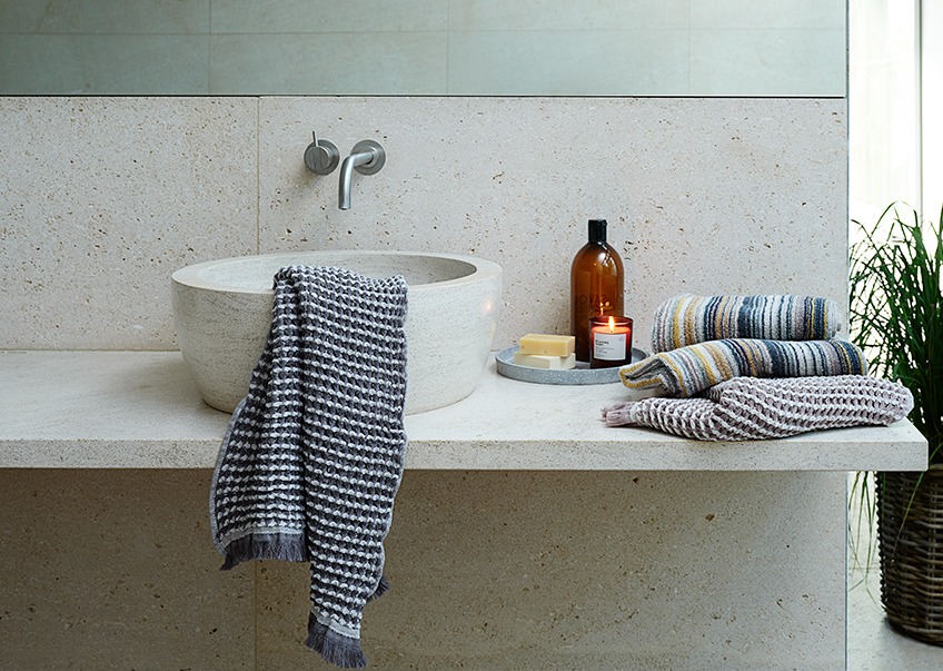 IDRE bath towels and hand towels and SEGERSTA striped towels Towels and guest towels at a bathroom sink