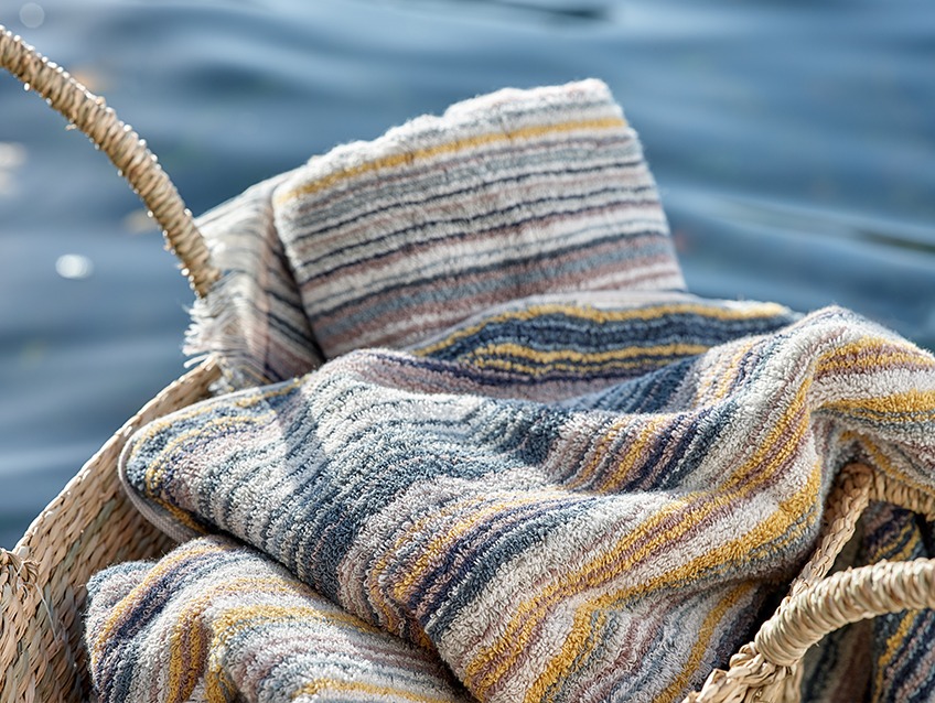 SEGERSTA striped towels Wicker basket with striped towels by a lake