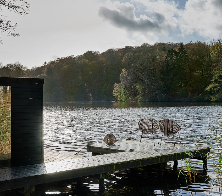 SEGERSTA striped towel, STRAND lantern and GJERLEV lounge chairs Bath towel hanging a lounge chair on jetty by a lake