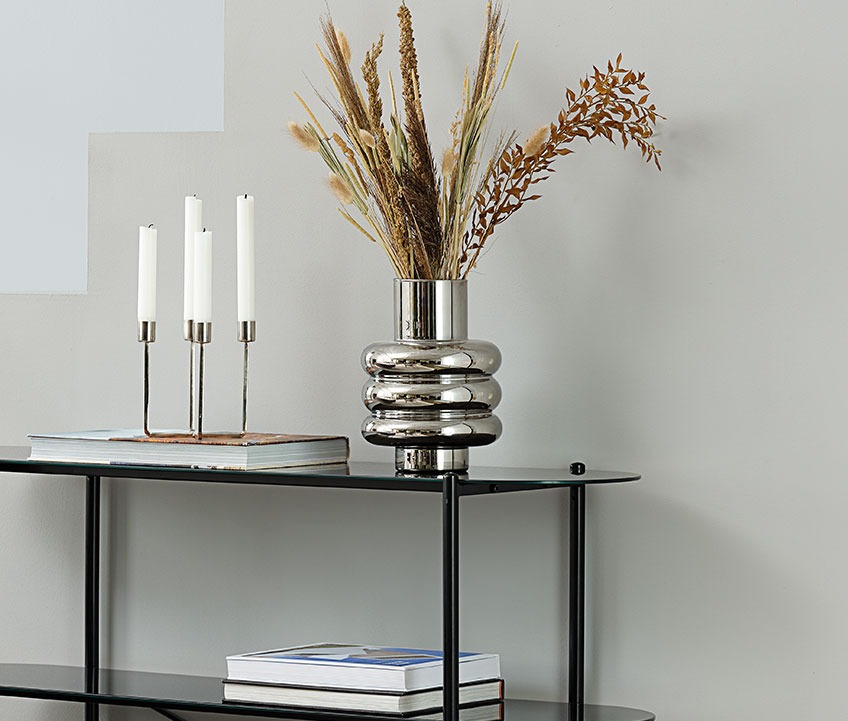 MAGNUS vase on PADBORG shelving unit Vase with silver look on a bookcase
