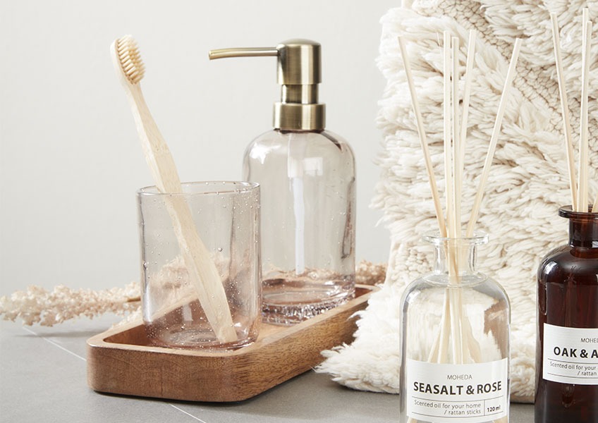 ESSVIK soap dispenser and toothbrush holder on ARDALA tray Soap dispenser and toothbrush holder made from recycled glass placed on wooden tray